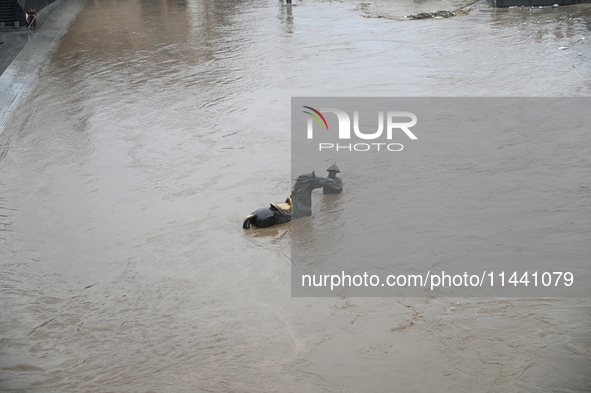 Bronze sculptures of horses and warriors are being seen submerged by floods at the Toudao wharf in Jilin City, Jilin province, China, on Jul...