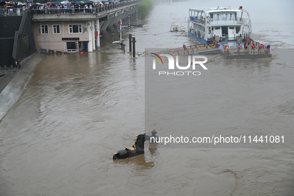 Bronze sculptures of horses and warriors are being seen submerged by floods at the Toudao wharf in Jilin City, Jilin province, China, on Jul...