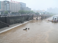 Bronze sculptures of horses and warriors are being seen submerged by floods at the Toudao wharf in Jilin City, Jilin province, China, on Jul...