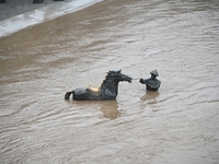 Bronze sculptures of horses and warriors are being seen submerged by floods at the Toudao wharf in Jilin City, Jilin province, China, on Jul...