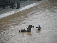 Bronze sculptures of horses and warriors are being seen submerged by floods at the Toudao wharf in Jilin City, Jilin province, China, on Jul...