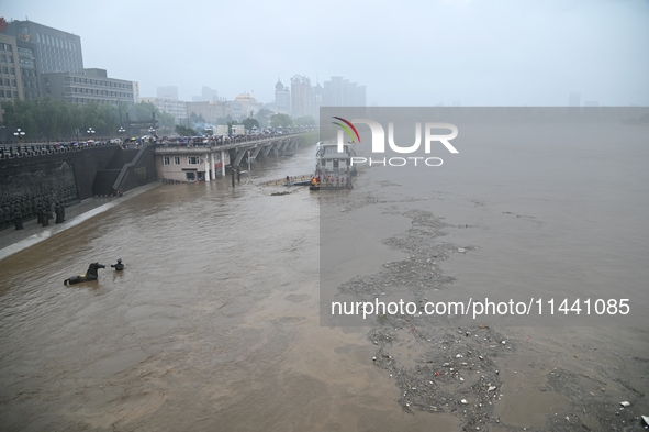 Bronze sculptures of horses and warriors are being seen submerged by floods at the Toudao wharf in Jilin City, Jilin province, China, on Jul...