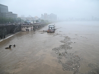 Bronze sculptures of horses and warriors are being seen submerged by floods at the Toudao wharf in Jilin City, Jilin province, China, on Jul...