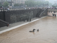 Bronze sculptures of horses and warriors are being seen submerged by floods at the Toudao wharf in Jilin City, Jilin province, China, on Jul...