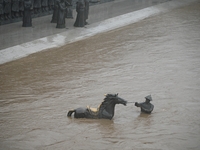 Bronze sculptures of horses and warriors are being seen submerged by floods at the Toudao wharf in Jilin City, Jilin province, China, on Jul...