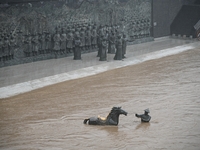 Bronze sculptures of horses and warriors are being seen submerged by floods at the Toudao wharf in Jilin City, Jilin province, China, on Jul...