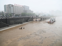 Bronze sculptures of horses and warriors are being seen submerged by floods at the Toudao wharf in Jilin City, Jilin province, China, on Jul...