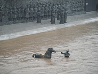 Bronze sculptures of horses and warriors are being seen submerged by floods at the Toudao wharf in Jilin City, Jilin province, China, on Jul...