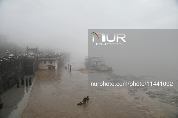 Bronze sculptures of horses and warriors are being seen submerged by floods at the Toudao wharf in Jilin City, Jilin province, China, on Jul...