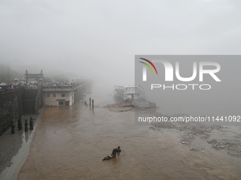 Bronze sculptures of horses and warriors are being seen submerged by floods at the Toudao wharf in Jilin City, Jilin province, China, on Jul...