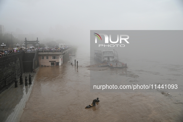 Bronze sculptures of horses and warriors are being seen submerged by floods at the Toudao wharf in Jilin City, Jilin province, China, on Jul...