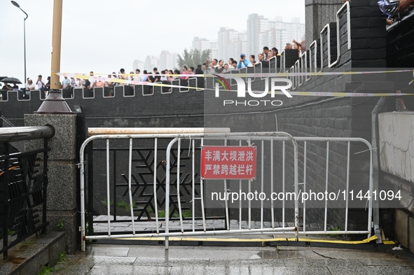 Citizens are watching the rising water at the Toudao wharf in Jilin City, Jilin province, China, on July 28, 2024. 