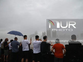 Citizens are watching the rising water at the Toudao wharf in Jilin City, Jilin province, China, on July 28, 2024. (