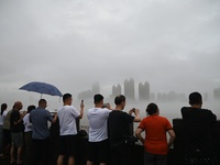 Citizens are watching the rising water at the Toudao wharf in Jilin City, Jilin province, China, on July 28, 2024. (