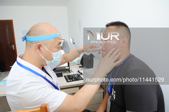 Young conscripts are attending a physical examination at a conscription medical examination station in Funing county, Yancheng city, East Ch...