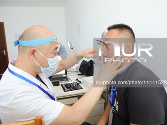 Young conscripts are attending a physical examination at a conscription medical examination station in Funing county, Yancheng city, East Ch...