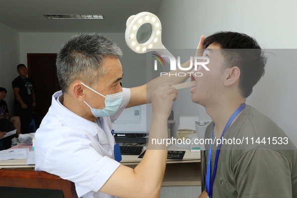 Young conscripts are attending a physical examination at a conscription medical examination station in Funing county, Yancheng city, East Ch...