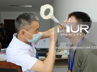 Young conscripts are attending a physical examination at a conscription medical examination station in Funing county, Yancheng city, East Ch...