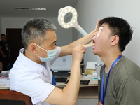 Young conscripts are attending a physical examination at a conscription medical examination station in Funing county, Yancheng city, East Ch...