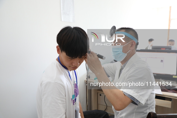 Young conscripts are attending a physical examination at a conscription medical examination station in Funing county, Yancheng city, East Ch...