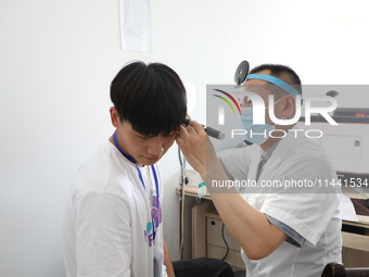 Young conscripts are attending a physical examination at a conscription medical examination station in Funing county, Yancheng city, East Ch...