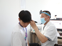 Young conscripts are attending a physical examination at a conscription medical examination station in Funing county, Yancheng city, East Ch...