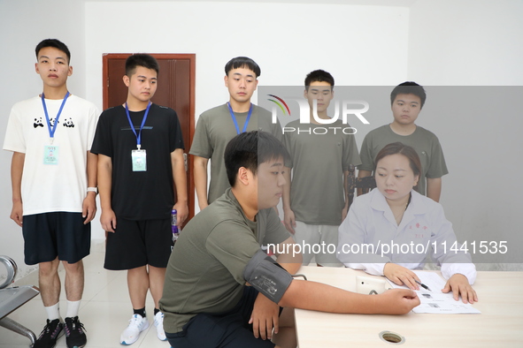 Young conscripts are attending a physical examination at a conscription medical examination station in Funing county, Yancheng city, East Ch...