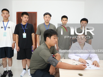 Young conscripts are attending a physical examination at a conscription medical examination station in Funing county, Yancheng city, East Ch...