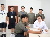 Young conscripts are attending a physical examination at a conscription medical examination station in Funing county, Yancheng city, East Ch...