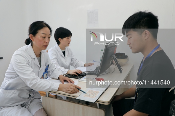 Young conscripts are attending a physical examination at a conscription medical examination station in Funing county, Yancheng city, East Ch...