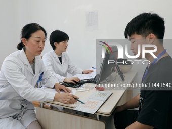 Young conscripts are attending a physical examination at a conscription medical examination station in Funing county, Yancheng city, East Ch...