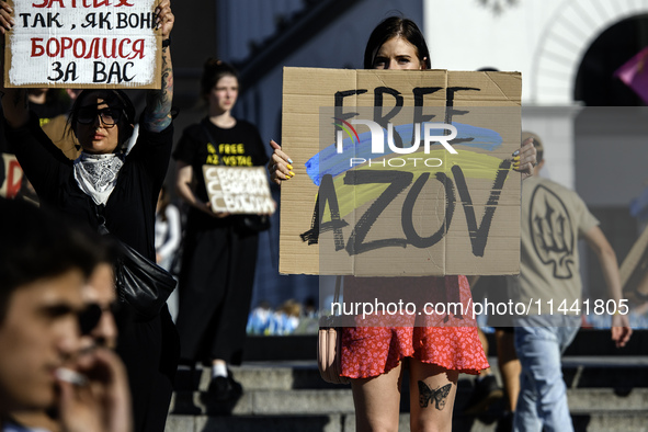 Ukrainian activists, relatives, and friends of soldiers who are defending the Azovstal Iron and Steel Works are holding placards calling on...