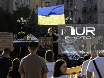 Ukrainian activists, relatives, and friends of soldiers who are defending the Azovstal Iron and Steel Works are holding placards calling on...