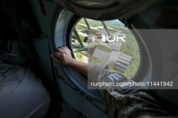 A gun is being seen through a porthole of a Mi-8MSB-V assault transport helicopter of the 16th Brody Separate Army Aviation Brigade in Ukrai...