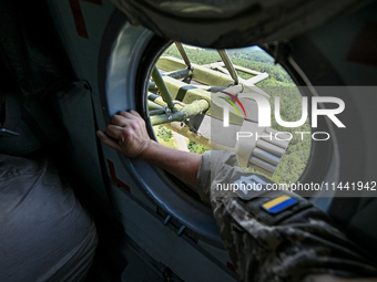 A gun is being seen through a porthole of a Mi-8MSB-V assault transport helicopter of the 16th Brody Separate Army Aviation Brigade in Ukrai...