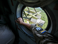 A gun is being seen through a porthole of a Mi-8MSB-V assault transport helicopter of the 16th Brody Separate Army Aviation Brigade in Ukrai...