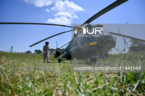 A flight engineer is checking the systems of a Mi-8MSB-V assault transport helicopter of the 16th Brody Separate Army Aviation Brigade in Uk...