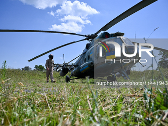 A flight engineer is checking the systems of a Mi-8MSB-V assault transport helicopter of the 16th Brody Separate Army Aviation Brigade in Uk...