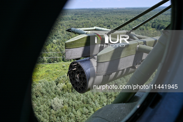 A gun is being seen through a porthole of a Mi-8MSB-V assault transport helicopter of the 16th Brody Separate Army Aviation Brigade in Ukrai...