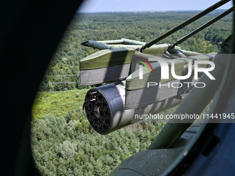 A gun is being seen through a porthole of a Mi-8MSB-V assault transport helicopter of the 16th Brody Separate Army Aviation Brigade in Ukrai...