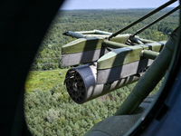 A gun is being seen through a porthole of a Mi-8MSB-V assault transport helicopter of the 16th Brody Separate Army Aviation Brigade in Ukrai...