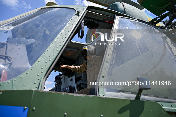 A flight engineer is checking the systems of a Mi-8MSB-V assault transport helicopter of the 16th Brody Separate Army Aviation Brigade in Uk...