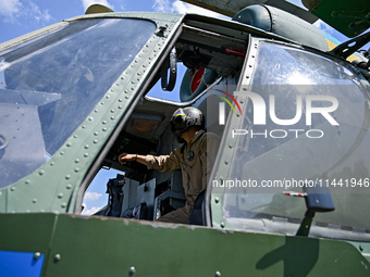 A flight engineer is checking the systems of a Mi-8MSB-V assault transport helicopter of the 16th Brody Separate Army Aviation Brigade in Uk...