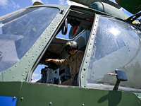 A flight engineer is checking the systems of a Mi-8MSB-V assault transport helicopter of the 16th Brody Separate Army Aviation Brigade in Uk...