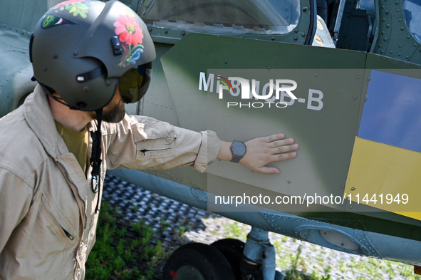 A flight engineer is checking the systems of a Mi-8MSB-V assault transport helicopter of the 16th Brody Separate Army Aviation Brigade in Uk...