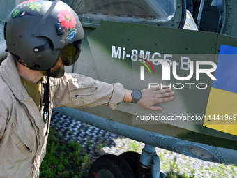 A flight engineer is checking the systems of a Mi-8MSB-V assault transport helicopter of the 16th Brody Separate Army Aviation Brigade in Uk...