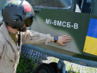 A flight engineer is checking the systems of a Mi-8MSB-V assault transport helicopter of the 16th Brody Separate Army Aviation Brigade in Uk...