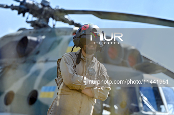 A flight engineer is standing by a Mi-8MSB-V assault transport helicopter of the 16th Brody Separate Army Aviation Brigade in Ukraine, on Ju...