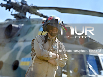 A flight engineer is standing by a Mi-8MSB-V assault transport helicopter of the 16th Brody Separate Army Aviation Brigade in Ukraine, on Ju...