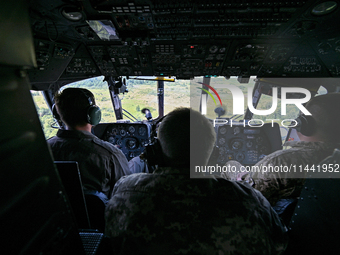 Crew members are in the cockpit of a Mi-8MSB-V assault transport helicopter of the 16th Brody Separate Army Aviation Brigade in Ukraine, on...